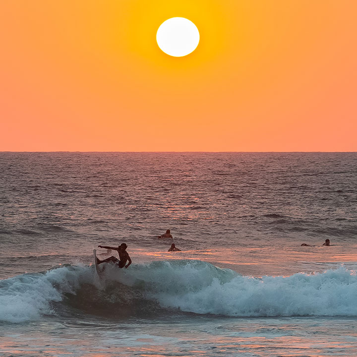 Group of friends surfing in Hikkaduwa beach