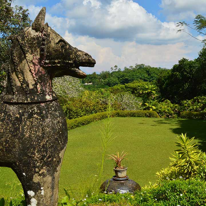 Contemporary statue an view of garden at property in Bentota