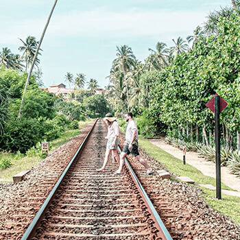 Couple crossing the railway tracks